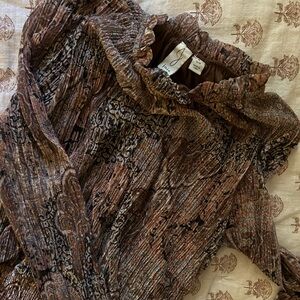 Long-sleeve, hip-cinching blouse with vintage pattern.